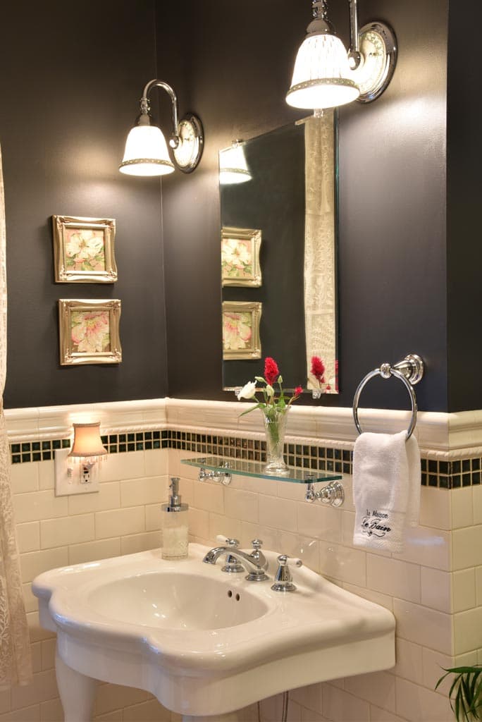 black walls white console sink by window white subway tile walls