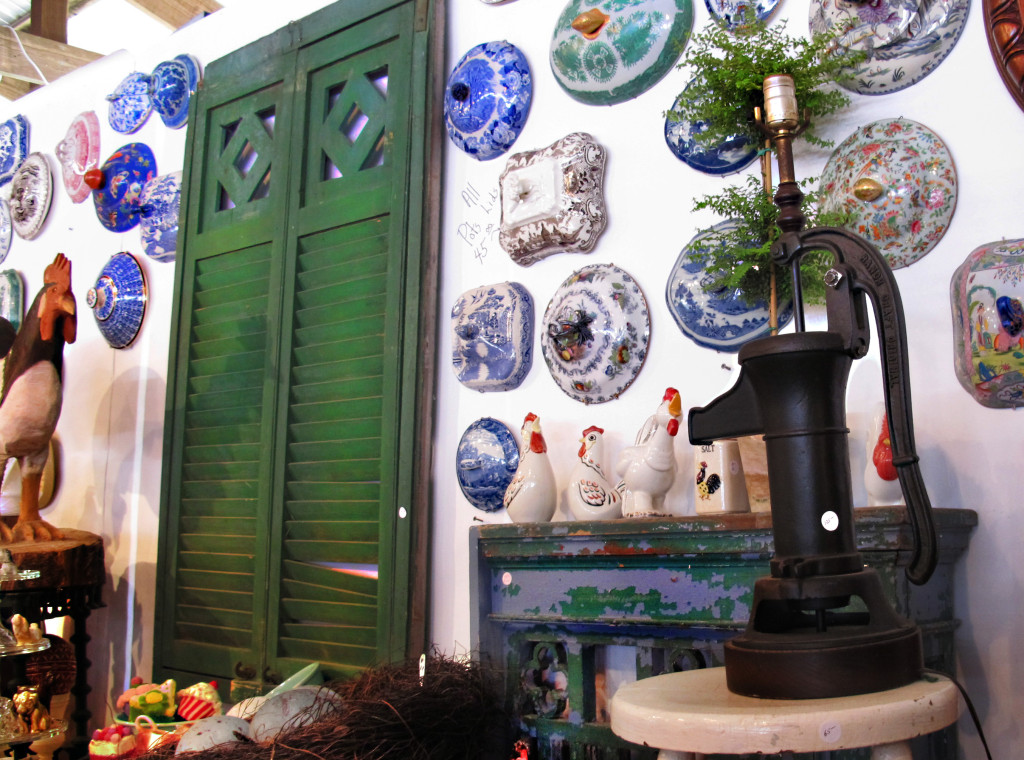 Different colored antique tureen lids displayed on wall